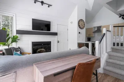 a living room with a couch and a fireplace at Arrowhead Retreat Ski-In-Out Pool Shuttle in Blue Mountains