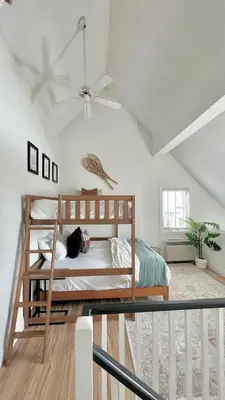 a bedroom with a bed and a ceiling fan at Arrowhead Retreat Ski-In-Out Pool Shuttle in Blue Mountains