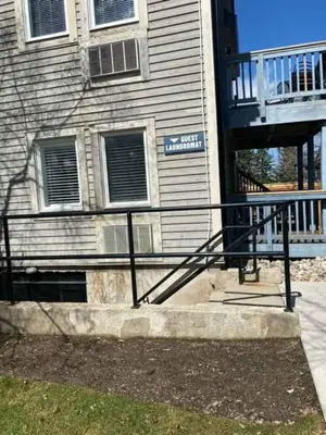 a building with a black railing in front of a building at Northern Peaks Ski In-Out Hot Tub Shuttle Access in Blue Mountains