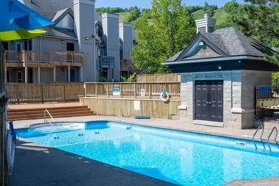 a swimming pool in front of a house at Northern Peaks Ski In-Out Hot Tub Shuttle Access in Blue Mountains