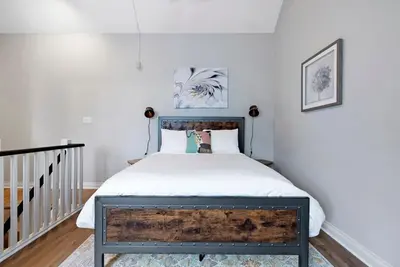 a bedroom with a bed with a wooden headboard at Mountainside Escape Ski-In-Out Pool Shuttle in Blue Mountains