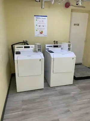 two washing machines sitting next to each other in a room at Blue Haven Ski-In-Out Pool Hot Tub Shuttle in Blue Mountains