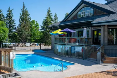 a house with a swimming pool in front of a house at Blue Haven Ski-In-Out Pool Hot Tub Shuttle in Blue Mountains