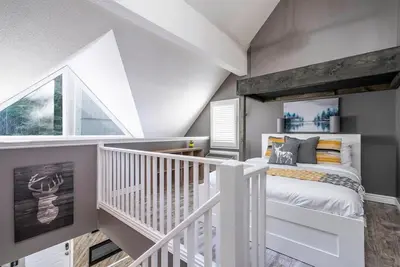 a small bedroom with a white bed and a window at Fox Ridge - Ski-In-Out Pool Hot Tub Shuttle in Blue Mountains