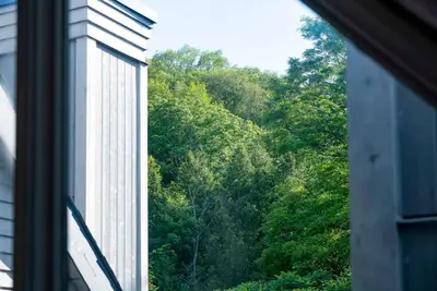 a window view of a forest of trees at Fox Ridge - Ski-In-Out Pool Hot Tub Shuttle in Blue Mountains
