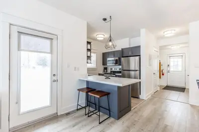 a kitchen with white walls and a large window at Rivergrass Oasis Across from Blue Mtn Hot Tub in Blue Mountains