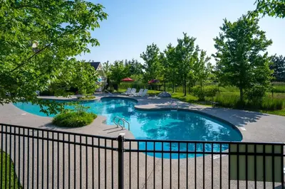 a swimming pool in a yard with a fence at Three Suns Across Blue Mtn Hot Tub & Shuttle in Blue Mountains