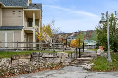 a house with a set of stone steps in front at The Blue - Walk to the Village Shuttle & Hot Tub in Blue Mountains