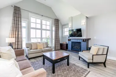 a living room with a couch and a fireplace at Sunny Days - Steps to Blue Mtn - Hot Tub & Shuttle in Blue Mountains