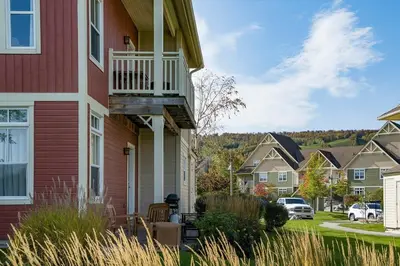 a house with a balcony on the side of it at Sunny Days - Steps to Blue Mtn - Hot Tub & Shuttle in Blue Mountains