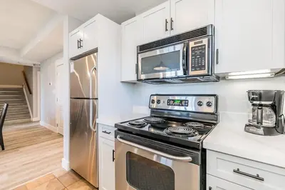 a kitchen with a stove and a microwave at Sunny Days - Steps to Blue Mtn - Hot Tub & Shuttle in Blue Mountains