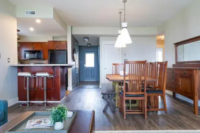 a kitchen and living room with a table and chairs at Bears Den - Hot Tub - Ski Views - Walk to Village in Blue Mountains