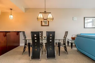 a dining room with a table and chairs at Raccoon Ridge - Village Walk - Hot Tub - Shuttle in Blue Mountains