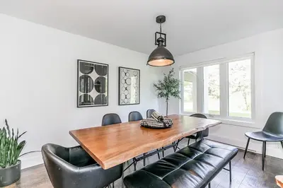 a dining room with a wooden table and leather chairs at Hip Hideaway - Family Fun Walk to the Village in Blue Mountains