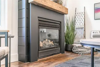 a fireplace in a living room with a fire place at Hip Hideaway - Family Fun Walk to the Village in Blue Mountains