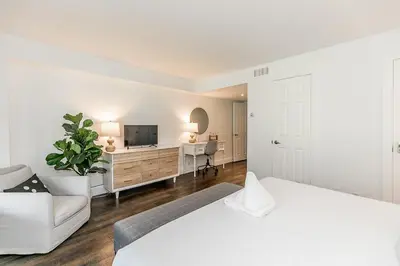 a bedroom with a bed and a tv and a couch at Hip Hideaway - Family Fun Walk to the Village in Blue Mountains