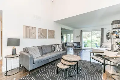 a living room with a couch and a table at Hip Hideaway - Family Fun Walk to the Village in Blue Mountains