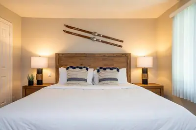 a bedroom with a large white bed with two lamps at Sierra Point - Walk to the Blue - Outdoor Pool in Blue Mountains