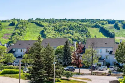 a group of houses with cars parked in a parking lot at Sierra Point - Walk to the Blue - Outdoor Pool in Blue Mountains