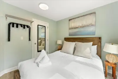 a bedroom with a white bed and a mirror at Sierra Peaks - Village and Golf retreat in Blue Mountains