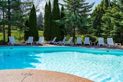a group of chairs sitting around a swimming pool at Sierra Peaks - Village and Golf retreat in Blue Mountains