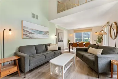 a living room with a couch and a table at Sierra Peaks - Village and Golf retreat in Blue Mountains
