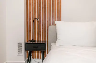 a bedroom with a bed and a night stand with a lamp at Sierra Summit - Walk to the Village family fun in Blue Mountains