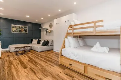 a bedroom with a bunk bed and a couch at Sierra Summit - Walk to the Village family fun in Blue Mountains