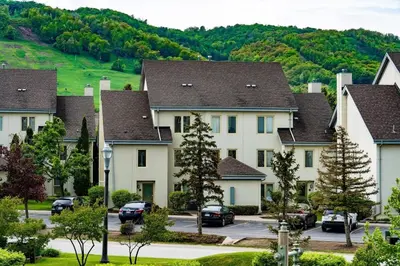 a row of houses with cars parked in a parking lot at Sierra Views - Steps to Blue Mountain Village in Blue Mountains