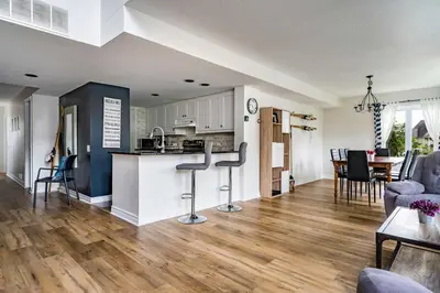 a kitchen and living room with a counter and chairs at Sierra Views - Steps to Blue Mountain Village in Blue Mountains