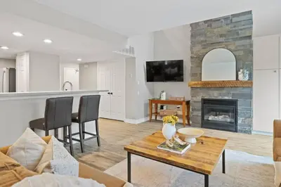 a living room with a table and a fireplace at Sierra Heights - Steps to Blue Mountain Village in Blue Mountains