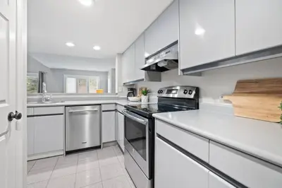 a kitchen with white cabinets and a stove top oven at Sierra Heights - Steps to Blue Mountain Village in Blue Mountains