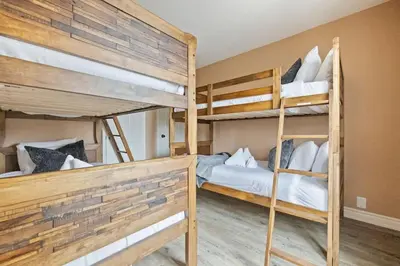 two bunk beds in a small room with at Sierra Heights - Steps to Blue Mountain Village in Blue Mountains