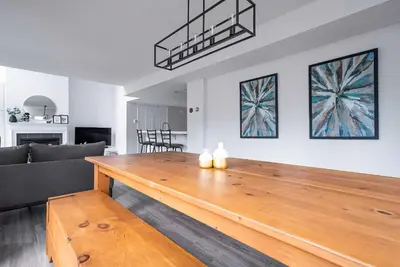 a large wooden table in a living room with a couch at Sierra Lookout - Steps to Blue Mountain Village in Blue Mountains