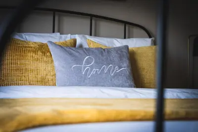 a bed with a pillow with the word time written on it at Sierra Lookout - Steps to Blue Mountain Village in Blue Mountains