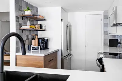 a kitchen with a sink and a refrigerator at View to Blue - Walk to the Village Mountain Views in Blue Mountains