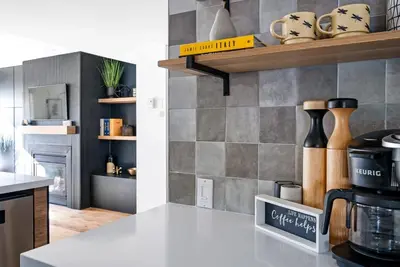 a kitchen with a white counter top with a counter sidx sidx sidx at View to Blue - Walk to the Village Mountain Views in Blue Mountains