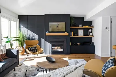 a living room with a couch and a fireplace at View to Blue - Walk to the Village Mountain Views in Blue Mountains