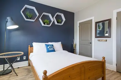 a bedroom with a bed with blue walls and a table at Hidden Haven - Shuttle to Blue - Private Patio in Blue Mountains