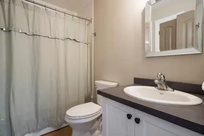 a bathroom with a white toilet and a sink at Hidden Haven - Shuttle to Blue - Private Patio in Blue Mountains