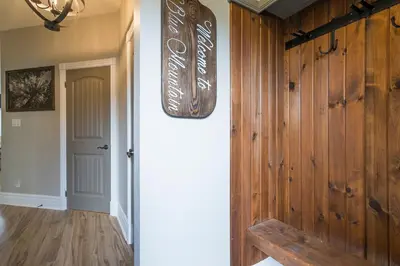 a hallway with a wooden wall with a sign on it at Hidden Haven - Shuttle to Blue - Private Patio in Blue Mountains