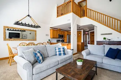 a living room with two couches and a table at Out of the Blue - Shuttle to Blue Walk & Trails in Blue Mountains