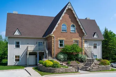 a large house with a brown roof at Still Winds - Private Patio - Shuttle to Blue in Blue Mountains