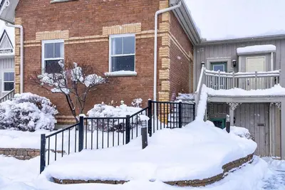 a house with snow on the ground in front of it at Snowy Mountain Summit & Sol - Shuttle - Patio in Blue Mountains