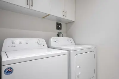 a white kitchen with a stove and a dishwasher at Blue Mountain Townhome - Patio Shuttle Trails in Blue Mountains