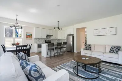 a living room and kitchen with a couch and a table at Luxury Mountain Townhome - Shuttle Patio & Trails in Blue Mountains