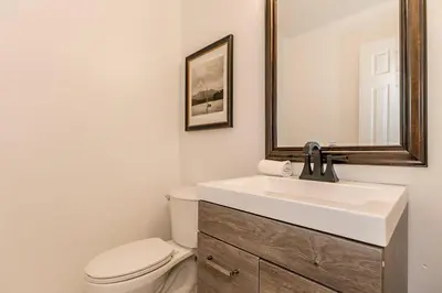 a bathroom with a sink and a toilet and a mirror at Snow Pine - 10 minute drive to Blue in Collingwood
