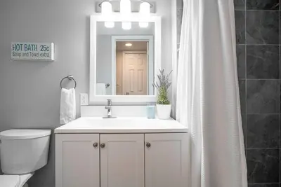 a bathroom with a sink and a toilet and a mirror at Memory Lane - Walk to the Village - Sleeps 10 in Blue Mountains