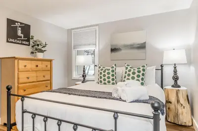 a bedroom with a large white bed with pillows at Memory Lane - Walk to the Village - Sleeps 10 in Blue Mountains