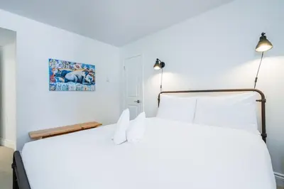 a bedroom with two white beds and two lamps at The Mountain House - Walk to the Village in Blue Mountains
